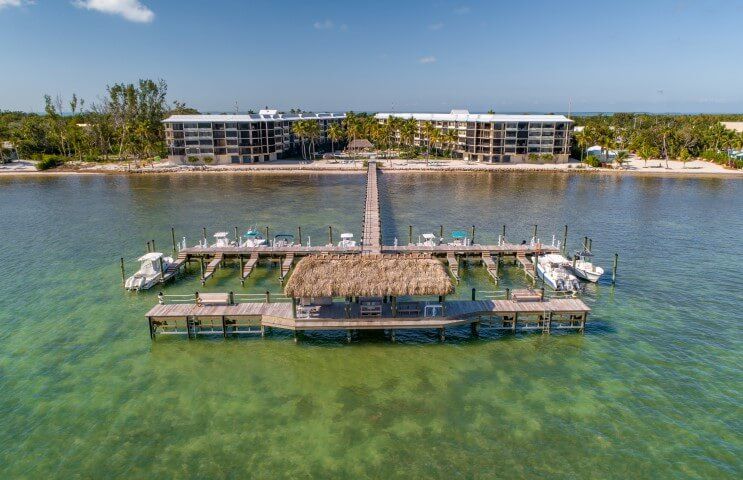 Bird's eye view from ocean, looking at dock and condos.