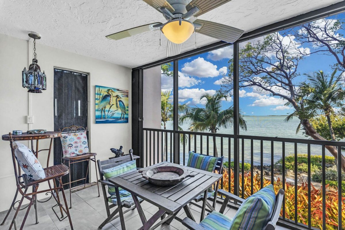 Screened in porch with view of the ocean.